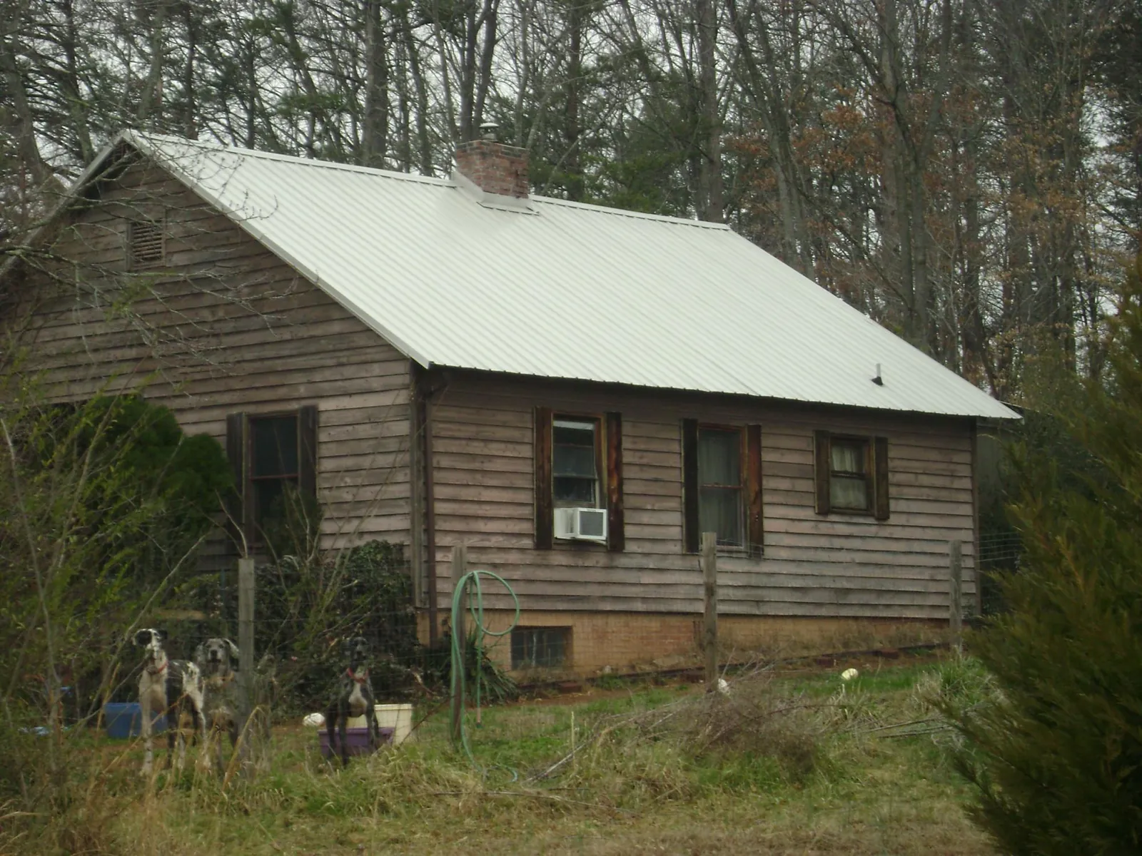 White metal roof on an old wood sided farmhouse, from a Metal Roof Installation job in Monrovia